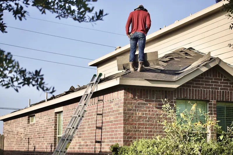 Professional roofer working on a residential roof in Central Lakes